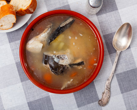 Fish soup with salmon bones and vegetablesの写真素材