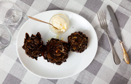Delicious roasted artichokes served with garlic aioli sauceの写真素材