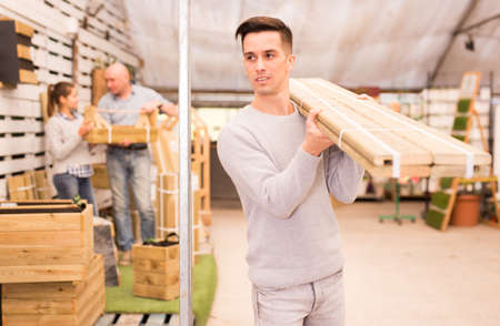 Male customer selecting construction materials in hardware storeの写真素材