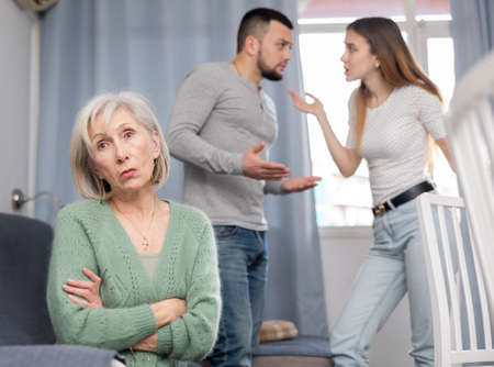 Offended mother dont speaking with adult children during home quarrelの写真素材