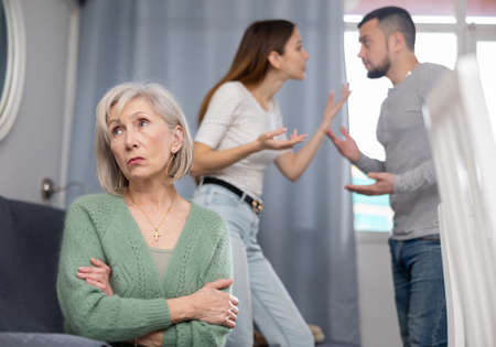 Offended mother dont speaking with adult children during home quarrelの写真素材