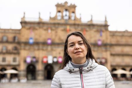 Smiling female tourist enjoying walking in Plaza Mayor in Salamancaの写真素材