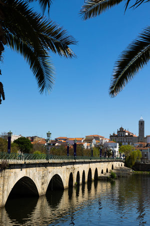 Urban landscape of city of Mirandela in the north of Portugal. Panoramic view of the banks of the river Tua with traditional Roman bridgeの写真素材