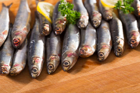Anchovies served on wooden surfaceの写真素材