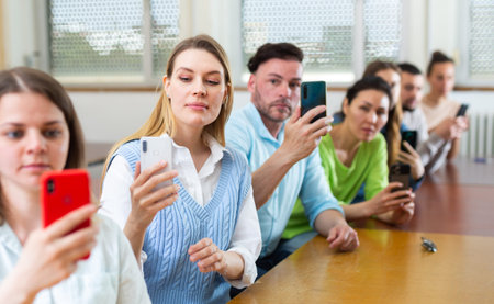 Group of students taking pictures with smartphones