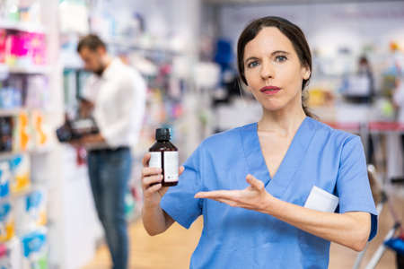 Portrait of female druggist advertising medicineの写真素材