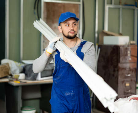Worker carrying construction materials at renovating objectの写真素材