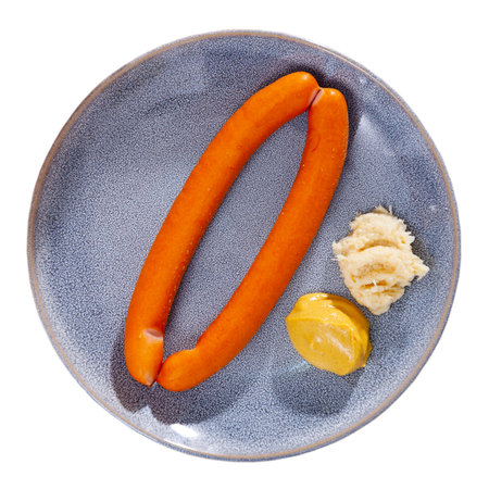 Two vienna sausages with mustard and horseradish on plateの写真素材