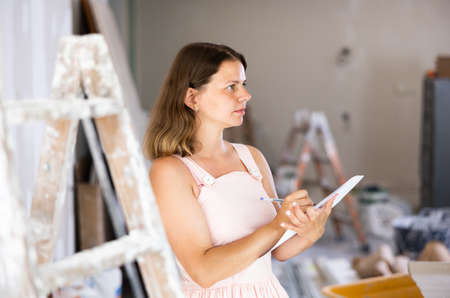 Woman construction manager checking project documentationの写真素材