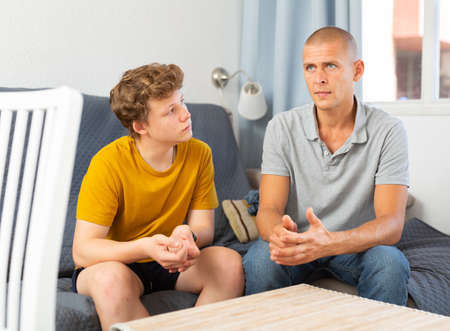 Father and his young son spending time at homeの写真素材