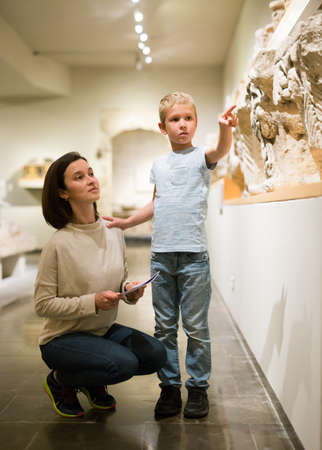 Woman and boy observing sculptures exhibitionの写真素材