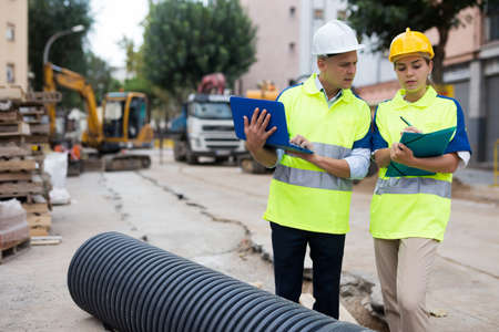 Male and female engineers in construction areaの写真素材