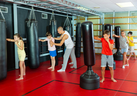 Group of kids boxing with punch bagsの写真素材