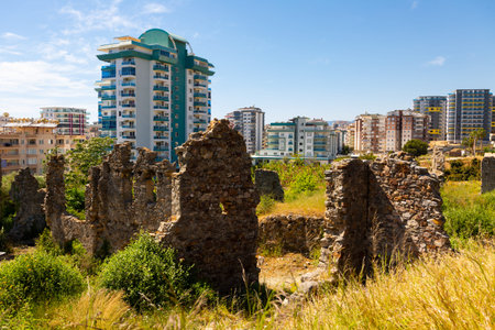 Naula Ancient City ruins among modern buildings of Mahmutlar