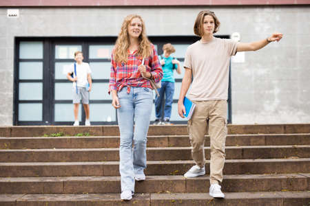 Teenagers going home after schoolの写真素材