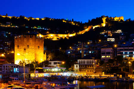 Night view of Alanya cityscape from harbor pier overlooking Red Tower and Castleの写真素材