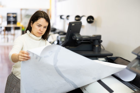 Worker in a printing and press centar check print quality