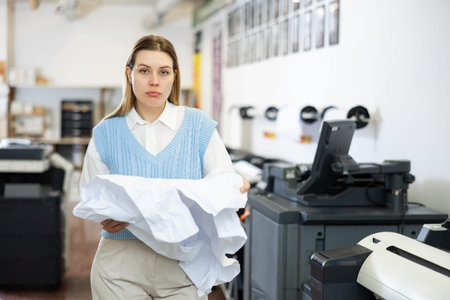 Sad printing office worker with crumpled paper