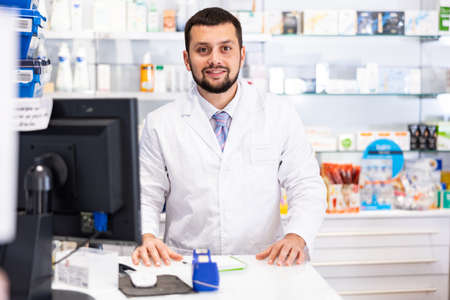 Portrait of positive male pharmacistの写真素材