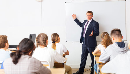 Adult teacher is giving lecture for students in class