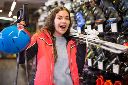 Portrait of woman standing in skiing gear during shopping in sport equipments shopの写真素材