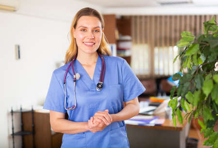 Positive female doctor posing in private clinicの写真素材