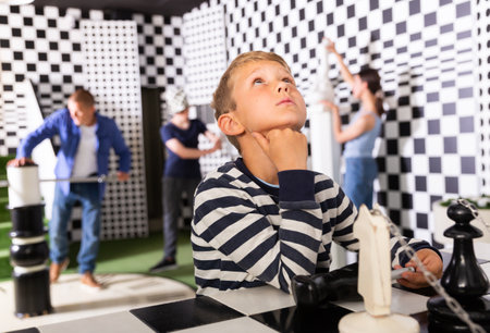 Portrait of a pensive boy child in a quest roomの写真素材