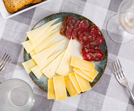 Appetizing slicing, smoked sausages and pieces of hard cheese
