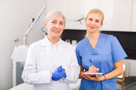 Two professional female cosmetologists in clinic of aesthetic medicineの写真素材