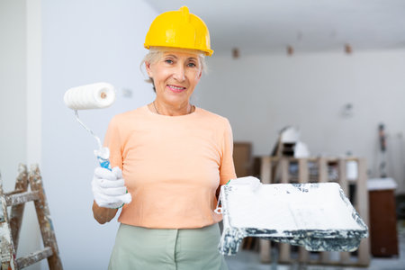 Mature woman posing with home renovation toolsの写真素材