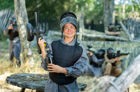 Portrait of cheerful woman paintball playerの写真素材
