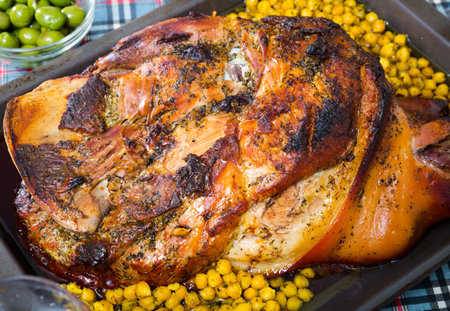 Plate with baked in oven gammon of bacon with garbanzo