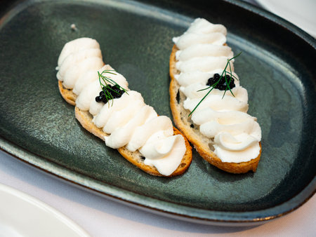 Fish butter and caviar sandwiches served as appetizer