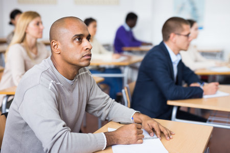 Focused man working at adult education classの写真素材