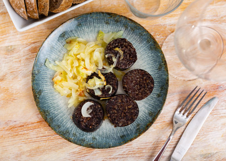 Spanish blood sausage morcilla served with grilled onion