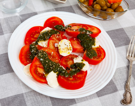 Fresh italian caprese salad with mozzarella and tomatoes on plateの写真素材