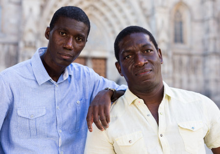 Portrait of happy friends tourists on tour of the European cityの写真素材