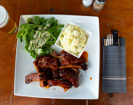 Popular dish of Belgian cuisine is marinated ribs with potatoes
