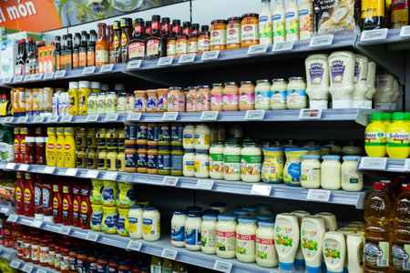 Bottles with various sauces on shelves of the grocery storeのeditorial素材