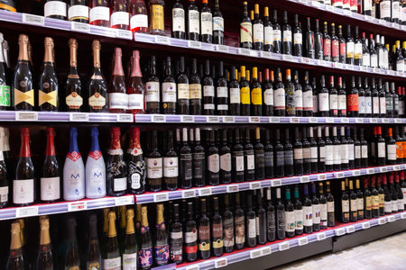 Variety of bottles with wine on shelves in storeのeditorial素材