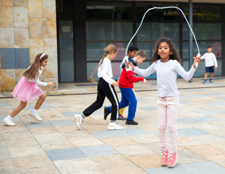 Tween African American girl skipping rope in schoolyardの写真素材