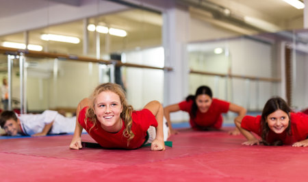 Karate kids doing push-ups in gymの写真素材