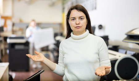 Friendly print shop employee invites customer to come inside