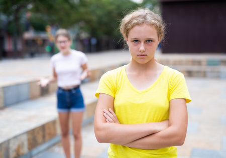 Two teenager girls quarreling in parkの写真素材