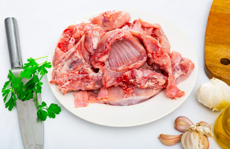 Rabbit sliced with herbs in white plate prepared for cookingの写真素材