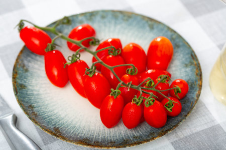 Close up of red ripe cherry tomato on tableの写真素材