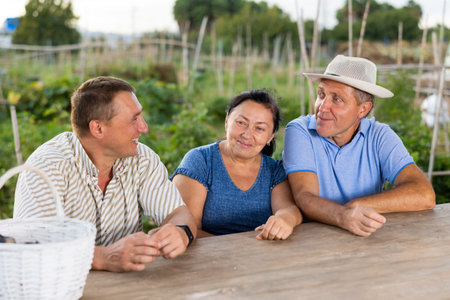 Positive family talking outdoors in backyard