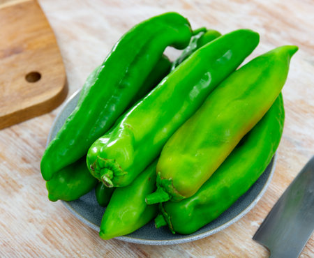 Green peppers on wooden table, cooking ingredientsの写真素材