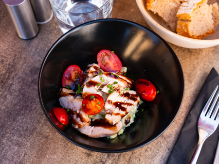 Avocado mayonnaise with grilled chicken and tomatoesの写真素材