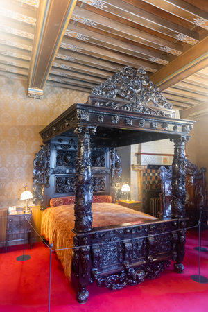 Dark wood bed with carved canopy in bedroom of De Haar Castleのeditorial素材